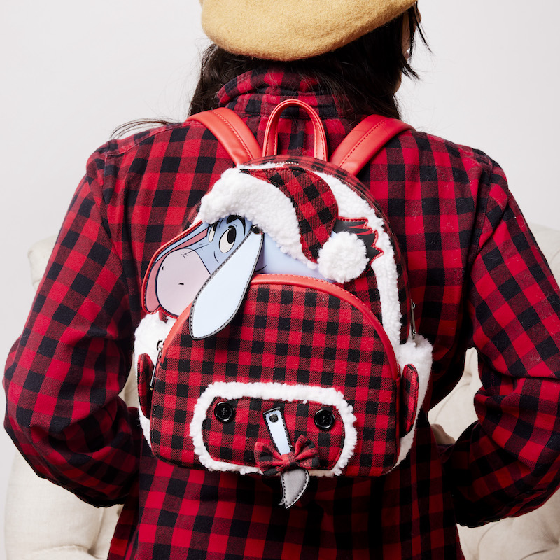 Image of someone wearing a red plaid shirt and wearing the Eeyore Plaid Pajama Sherpa Mini Backpack 